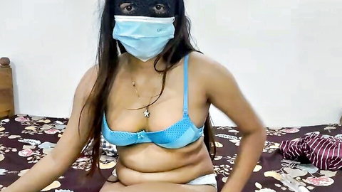 Brunette Asian babe in sheer blue bra showing tits and white panties sitting on bed