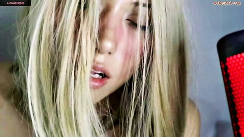 Wendy Daniela seductive close-up as blonde Asian cam girl in Chaturbate tits tease