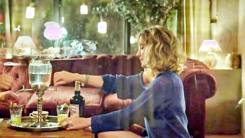 Ludivine Sagnier blonde in blue sweater pouring drink on couch in hot film scene