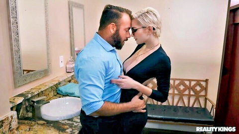 Chad White intimately embraces busty blonde in low-cut black dress