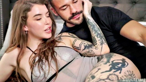 Eden Ivy in sheer lingerie embraced by tattooed man in intense adult scene