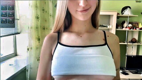 Jinnyjaquins blonde camgirl in tight white crop top teasing on Chaturbate