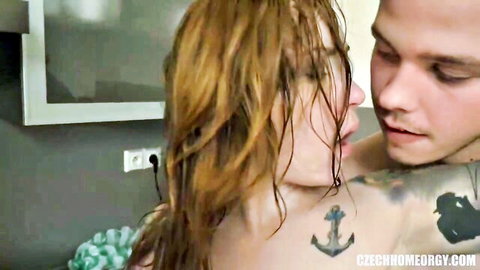 Wet brunette babe kissing tattooed stud passionately with bare tits pressed against his chest