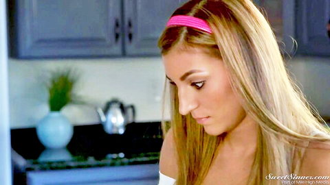 Blonde babe with big tits in low-cut top looking seductive in kitchen
