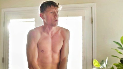 Shirtless handsome Caucasian man with curly hair, surprised expression in adult video
