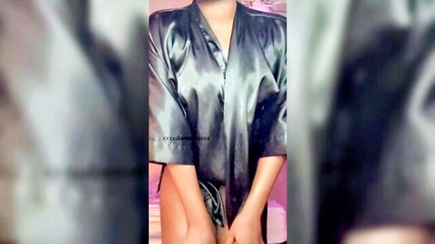 Sexy woman in silky robe teasing undress with oil shine