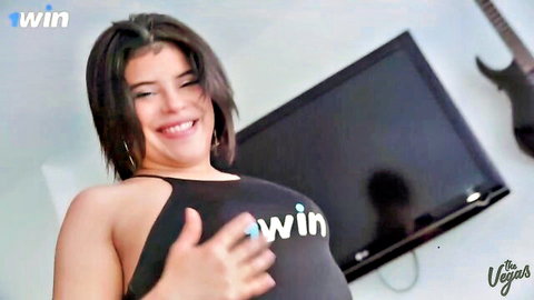 Smiling Selena Vega in black tank top, curvy Venezuelan beauty thumbs up