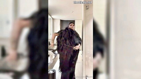 Mia Khalifa seductively posing in open fur coat striptease