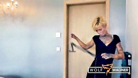 Blonde tattooed skinny babe with medium tits in black dress teasing at hotel door