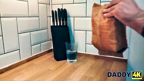 Sofia Smith in teasing kitchen scene with bag, knives, and water glass