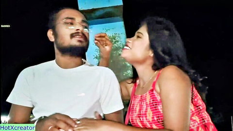 Indian couple in romantic moment as bearded man caresses smiling woman's face intimately