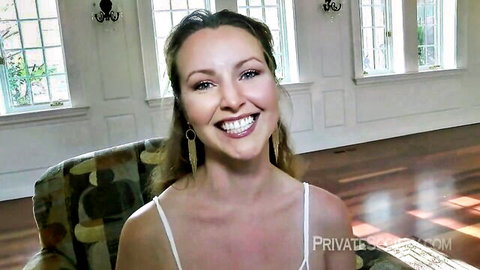 Curvy blonde beauty smiling seductively in thin white top