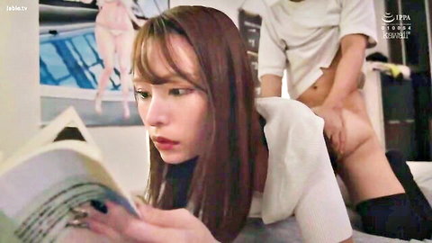 Asian babe in white shirt reads book on bed with bare ass exposed as man gropes her thighs