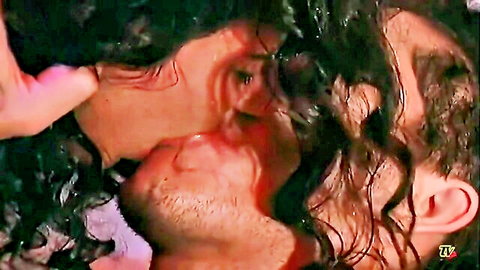 Wet-haired couple passionately kissing in steamy intimate scene
