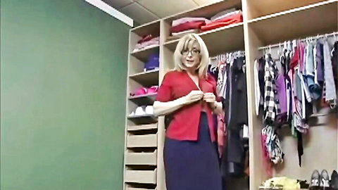 Nina Hartley in red cardigan and skirt, elegant wardrobe tease