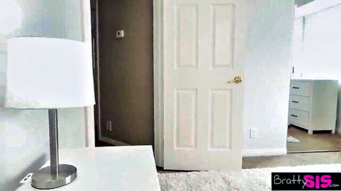 Bratty sis bedroom interior with white lamp nightstand open door and dresser