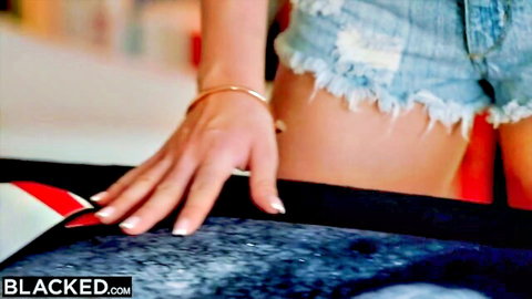 Kylie in ripped denim shorts, hand reaching for Anton's BBC in Blacked interracial scene