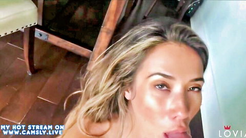 Seductive blonde sticks out wet tongue teasing cock in glossy live cam closeup