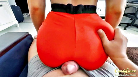 Thick ass babe in tight red leggings grinds on cock with pink glans bulging out visibly.