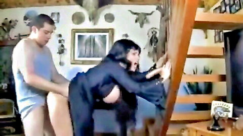 Goldie Blair as Elvira in black dress, bent over for cameraman doggy style