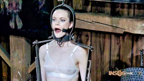 Hazel Hypnotic gagged in metal bondage harness and see-through bra