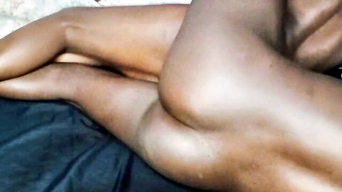 Oiled ebony babe's shiny ass cheeks spread exposing wet pussy from side