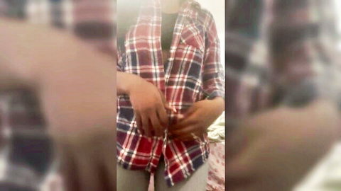 Amateur woman in open plaid shirt teasing with black bra visible