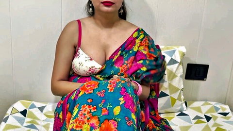 Hot Desi stepmom in colorful saree and low-cut blouse showing deep cleavage