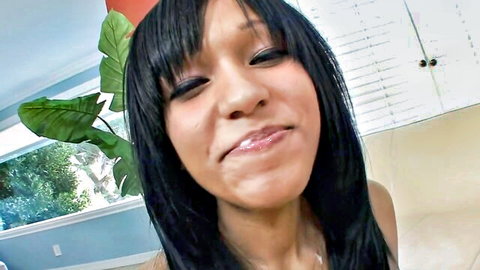Seductive ebony teen with bangs smirks and puckers plump lips teasingly closeup