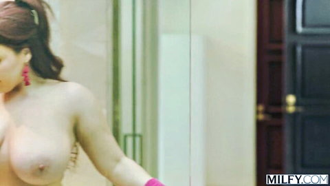 Nude redhead with pink gloves posing seductively in MILFY threesome preview