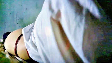 Plump ass cheeks exposed with red thong pulled aside teasing tight hole on bed