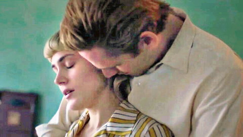 Suited man passionately kissing blonde woman's neck in steamy clothed embrace