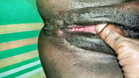 Close-up of ebony woman fingering wet pussy intensely