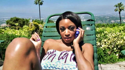 Ebony MILF Gigi Kitty in strapless dress on phone call outdoors