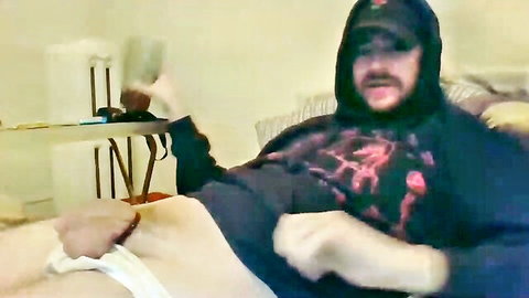 Bearded man in hoodie pulls down white underwear to stroke his hard cock solo