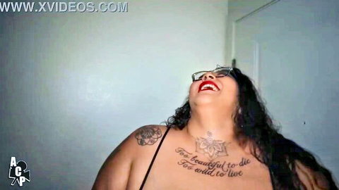 Curvy Latina Crystal Blue laughing in sexy lingerie with tattoos
