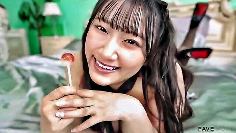 Seductive Japanese babe with huge natural tits teases with lollipop