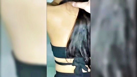 Sexy South Asian woman in black crisscross top showing bare back and long wet hair