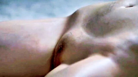Close-up of Asian woman's exposed vulva with pubic hair in erotic scene