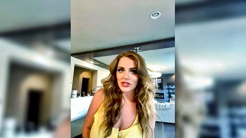 Busty blonde housewife in low-cut yellow top, solo tease at home
