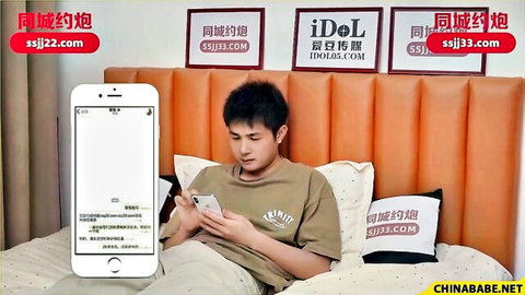 Asian man in casual t-shirt sitting on bed, viewing phone screen, amateur style