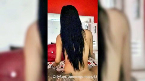Megan Lopez nude booty view with long black hair, sitting on bed