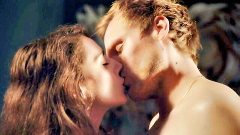 Brunette with medium tits passionately kissing topless redhead hunk in steamy nude embrace