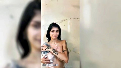 Curvy tattooed brunette Arab babe in shower teasing by covering huge tits with arms