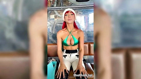 Sexy redhead in skimpy green bikini top and tight white pants teasing seductively in bus
