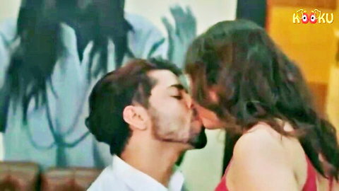Indian couple in passionate kiss, woman in red dress, man in white shirt