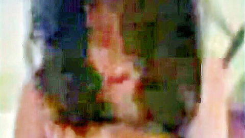 Blurry Asian solo girl with exposed tits sucking on long dildo