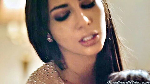 Close-up of seductive brunette in lesbian kiss scene, glossy lips and smoky eyes