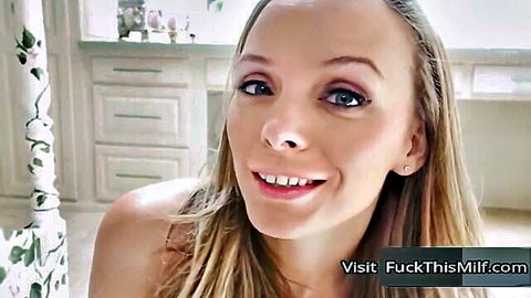 Smiling blonde MILF babe topless in kitchen teasing viewers