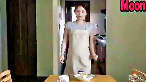 Japanese housewife in apron teases in kitchen cheating scene